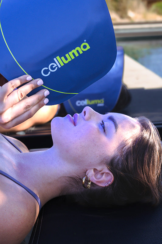 women with brown hair putting on a celluma led light panel
