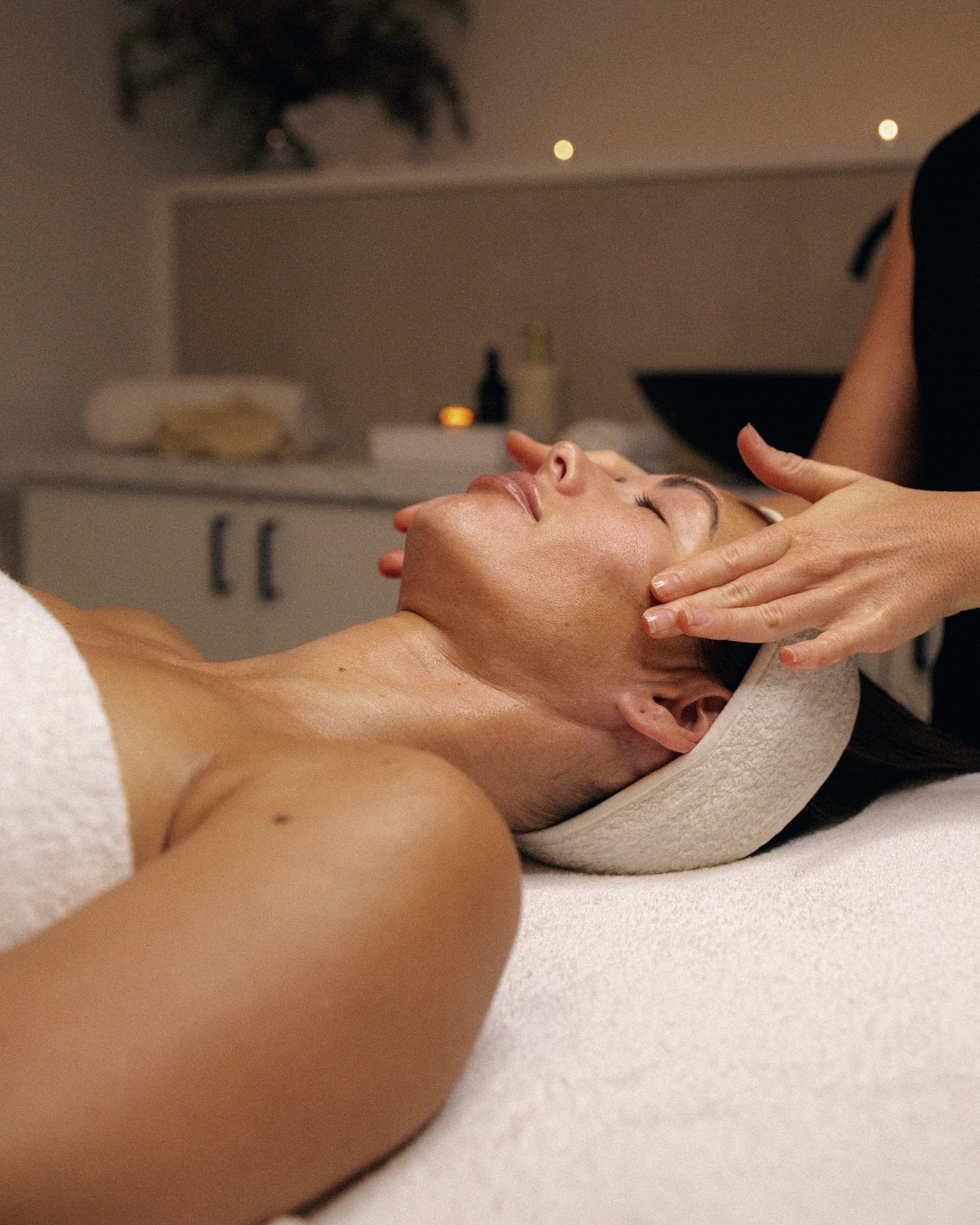 Person receiving a facial massage in a spa setting